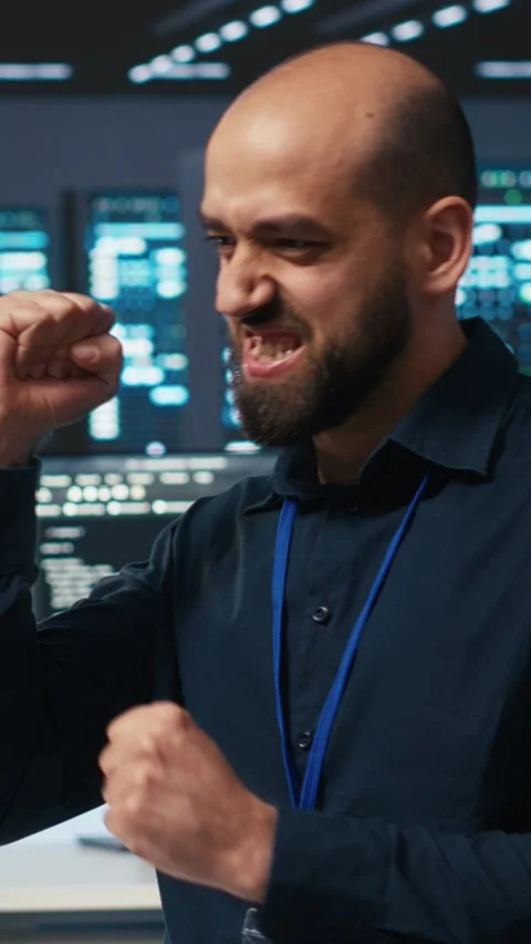 Vertical video Cheerful man pleased after using PC to fix server cabinets errors Stock Footage 274679522