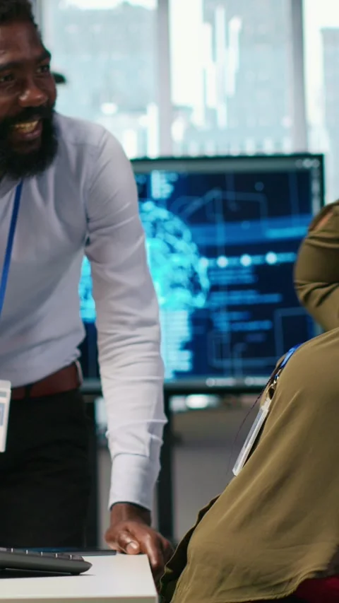 Vertical video Cheerful programmers in office enjoying conversation while Video stock 312708692
