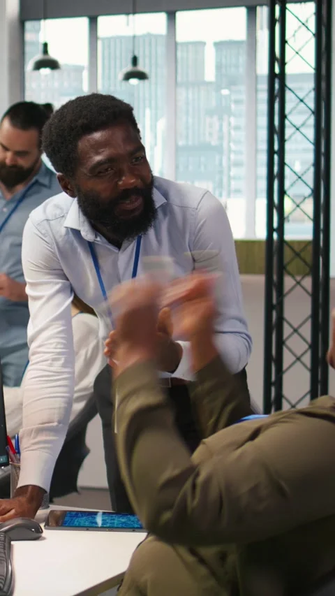 Vertical video Cheerful programmers in office enjoying conversation while Stock Footage 312768703