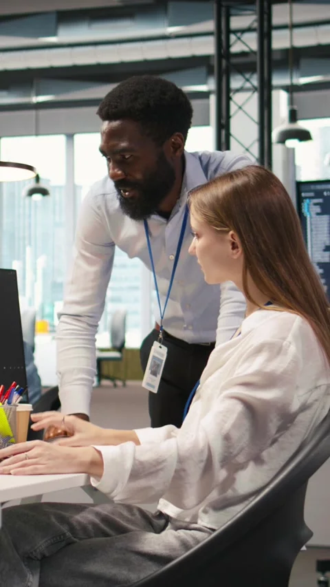 Vertical video Cheerful startup manager satisfied with progress of intern Stock Footage 312709458