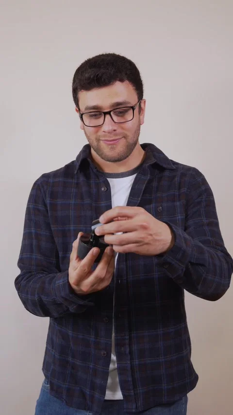 Vertical video: Cheerful white man, wearing blue and white clothes, smellin.. Stock Footage 236678009