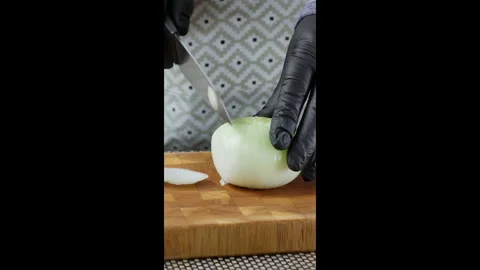 Vertical video. Chef cuts white onion into thin slices. Stock Footage 302637312