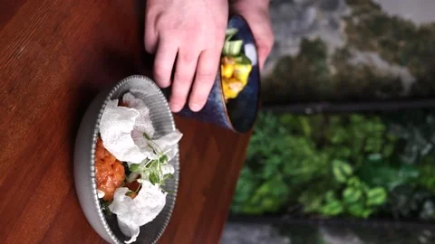 Vertical video the chef serves an Asian dish on the table Stock Footage 176390345