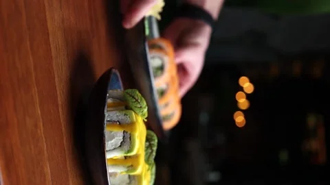 Vertical video the chef serves rolls on a wooden table Stock Footage 176390728