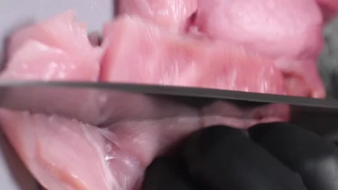 Vertical video. Chef slicing fresh pork tenderloin on a cutting board. Video stock 211808076