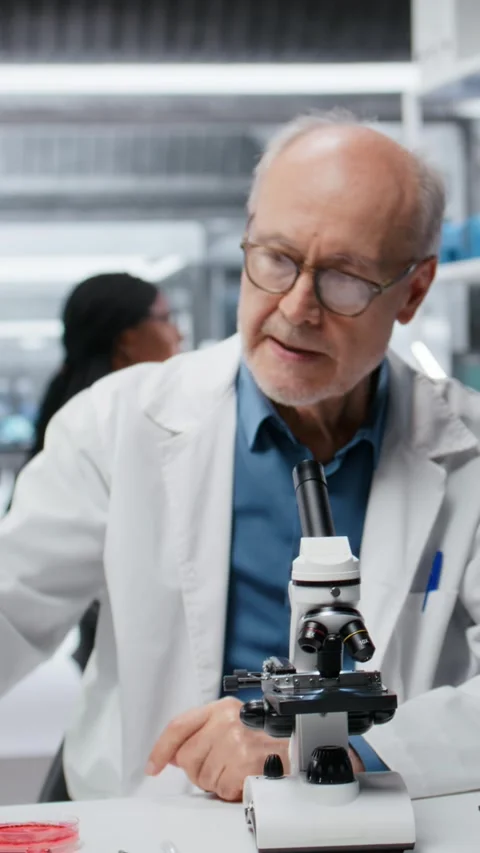 Vertical video Chemical engineer in lab inspecting chemical compounds using Stock Footage 326011021