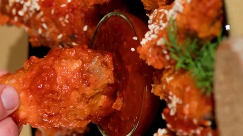 Vertical video. Chicken Wing is Dipped into a Ketchup Bowl on a Table. Stock-Footage 254488667