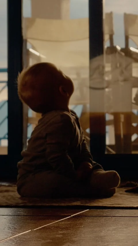 Vertical video Child explores his house by looking around while sitting Stock Footage 303696992