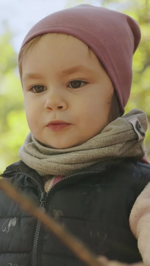 Vertical video. Child exploring nature and having a great time, walking through Stock Footage 308457835