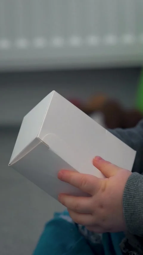 Vertical Video of Child Hands Opening Small Box Stock Footage 327481947