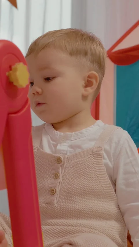 Vertical video Child joyfully draws on a blackboard during creative playtime in Stock Footage 329619612