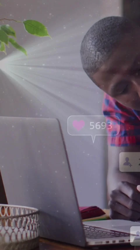 Vertical video: Child leaning over laptop, typing and creating floating icons Stock Footage 331383295