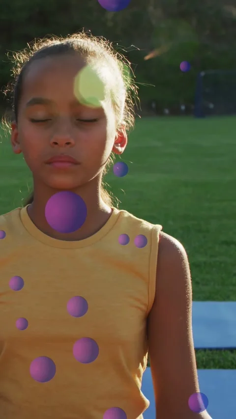 Vertical video: Child meditating on blue mat sun making green flare, moving Stock Footage 333556026