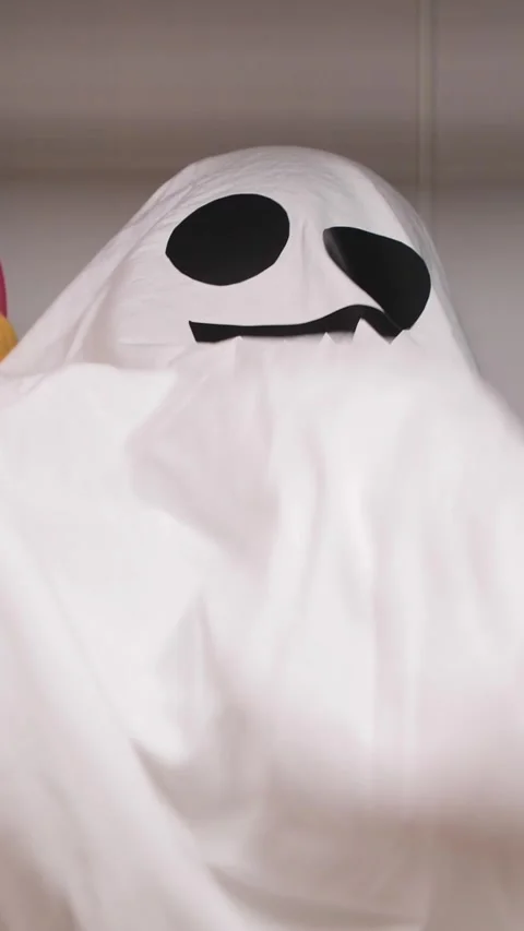 Vertical video child playing ghost in closet. Playful ghost in a child's closet Stock Footage 284725624