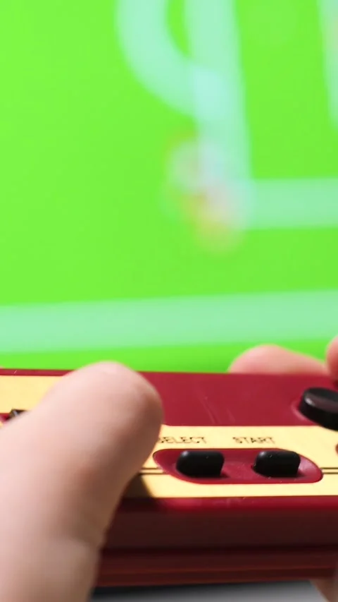 Vertical video Child playing retro video games using controller and television Stock Footage 302657541