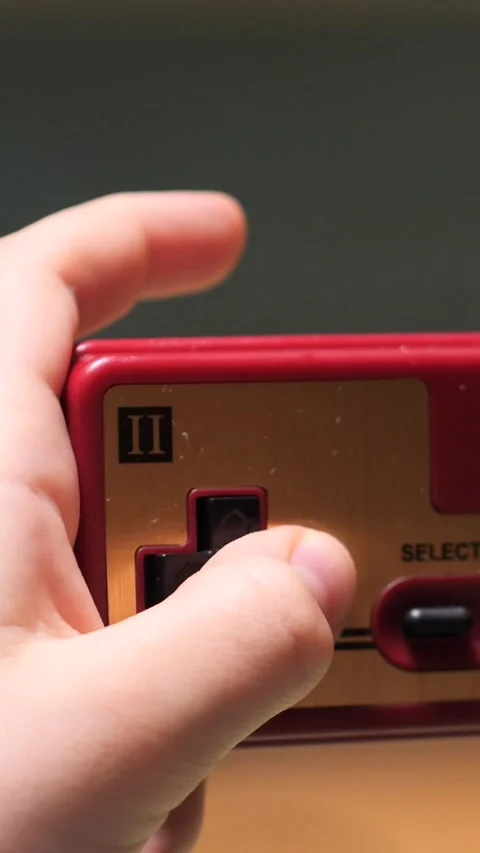 Vertical video Child playing with retro gamepad controller Video stock 302657716