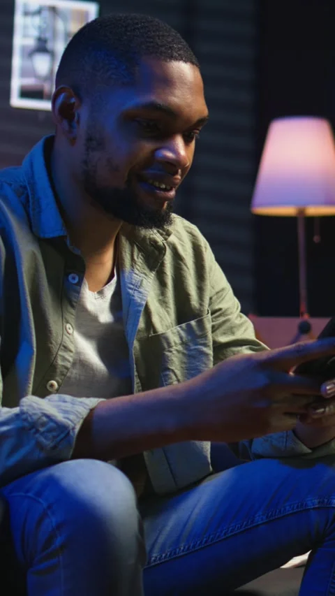 Vertical Video Chill self employed guy enjoying a break with his mobile phone on Stock Footage 308200326