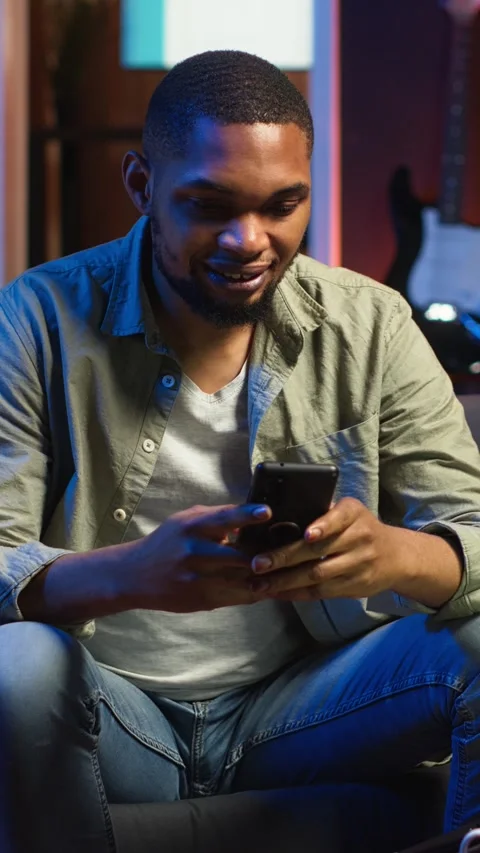 Vertical Video Chill self employed guy enjoying a break with his mobile phone on Stock Footage 308202157