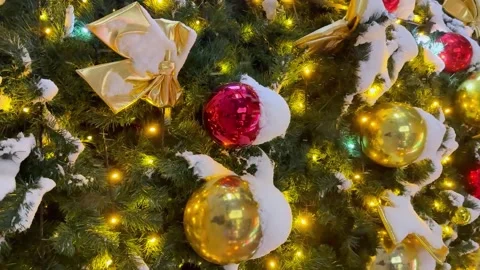 Vertical video of Christmas tree decorated with golden bows, colorful ornaments Stock Footage 296592811