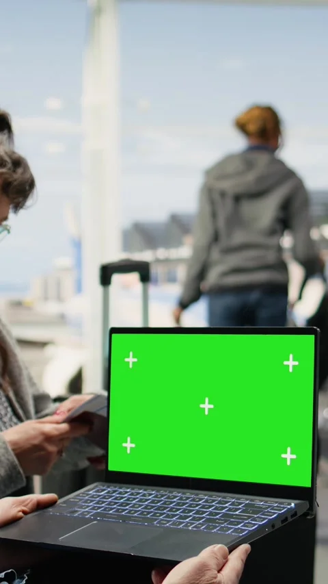 Vertical Video Chroma key on laptop screen used by senior people in airport Stock Footage 344373441