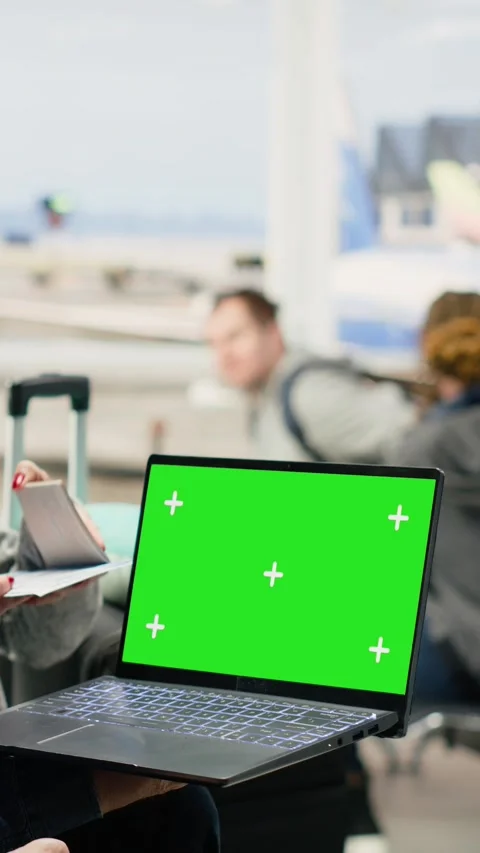 Vertical Video Chroma key on laptop screen used by senior people in airport Stock Footage 344374957