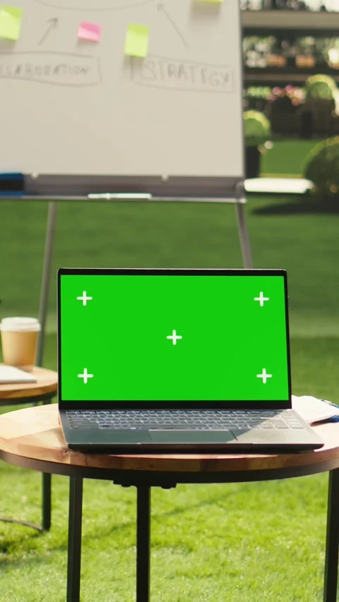 Vertical Video Chroma key mockup laptop on round table near lounge chairs Stock Footage 339070249