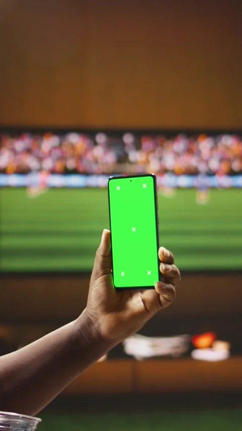 Vertical video Chroma key phone used by happy football fans watching match Video stock 338185247