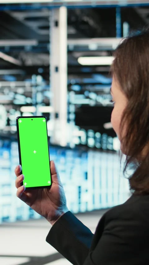 Vertical video Chroma key smartphone used by data center admin to troubleshoot Stock Footage 329316305