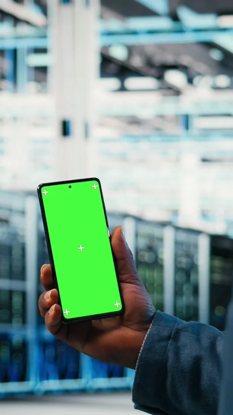 Vertical video Chroma key smartphone used by server room employee to monitor Stock Footage 330201704