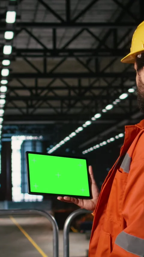 Vertical Video Chroma key tablet, engineer with hard hat, heavy industry Stock Footage 330085423