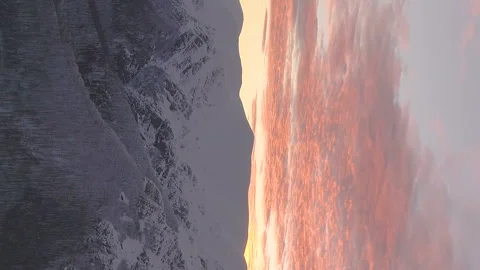 Vertical video of cinematic winter sunset in beautiful snowy mountain landscape Stock Footage 230637476