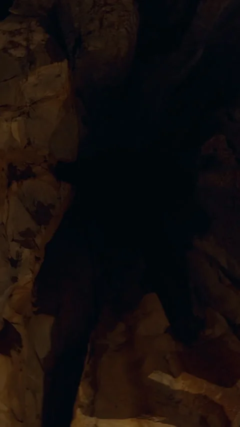 Vertical video. Circular Look Around Inside Dim Cave Showing Tall Rough Rock Wal Stock Footage 323470045