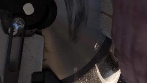 Vertical video. A circular saw cuts a wooden board. The chip is illuminated by Stock-Footage 250453800