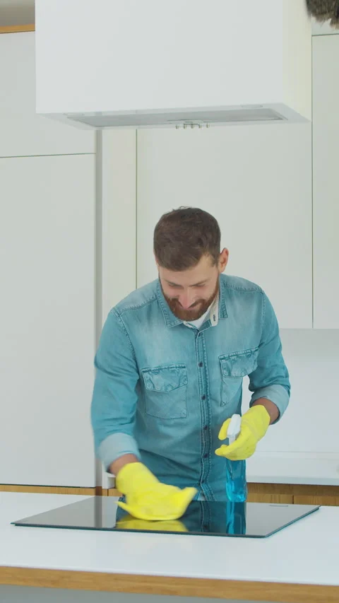 Vertical Video Cleaning service team man and woman at work in kitchen. Stock Footage 337991990