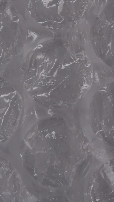 Vertical video. Clear bubble wrap texture with large air-filled pockets, Stock Footage 290998653