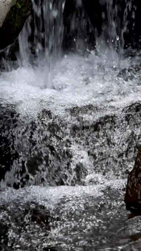 Vertical video of clear small waterfall splash Stock Footage 320982127