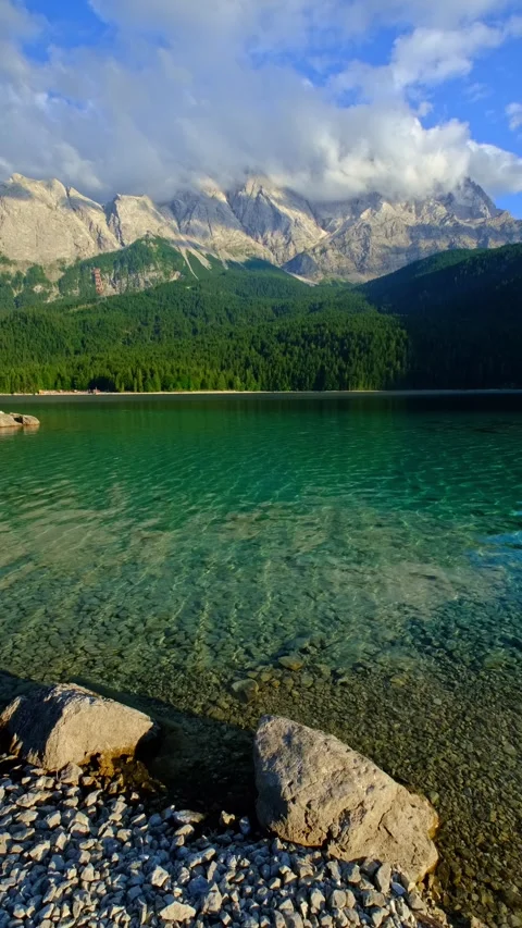 Vertical video of clear water at Eibsee lake with Zugspitze mountains Germany Stock Footage 332023533