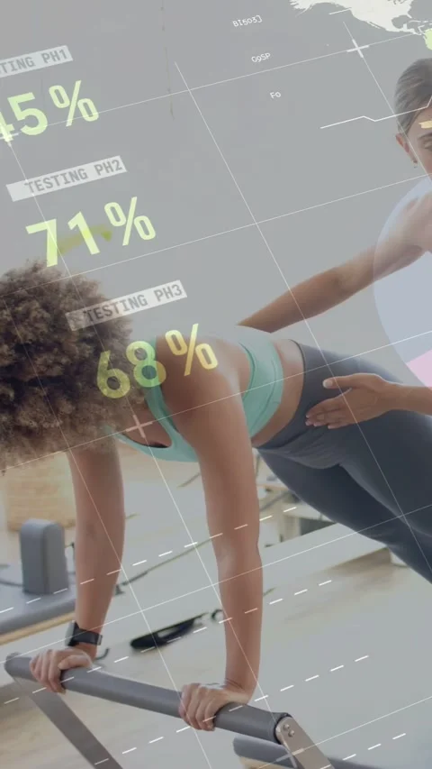 Vertical video: Client bracing on reformer, trainer entering cueing pelvis while Stock Footage 333555950