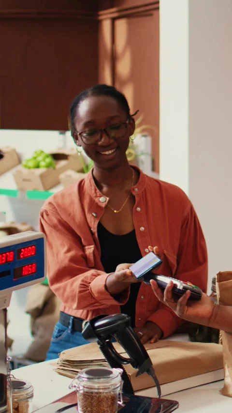 Vertical Video Client using nfc payment at pos to buy eco products Stock Footage 262052085