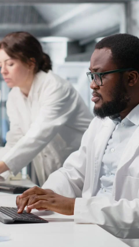 Vertical video Clinical microbiologist in lab looking at blood sample in test Stock Footage 319597595