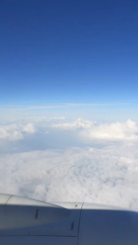 Vertical video of close-up of an airplane engine with a view of clouds belo.. Stock Footage 294342426