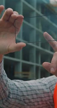 Vertical video. Close up Architect or Engineer using smartphone transparent h Stock Photos
