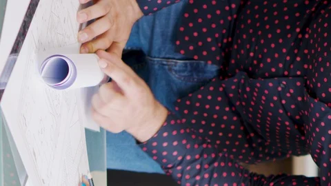 VERTICAL VIDEO - Close up of architects drawing on blueprints Stock Footage 117468812