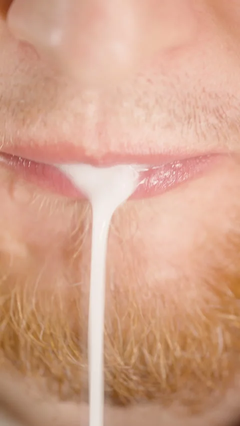 Vertical video. Close-Up of Bearded Man Spitting White Liquid After Rinsing Stock Footage 306438755