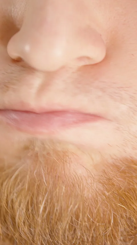 Vertical video. Close-Up of a Bearded Man Drinking Green Liquid from a Small Stock Footage 306445545