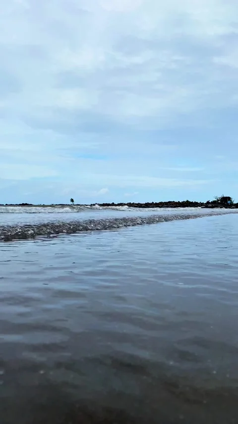 Vertical video Close-up of blue Ocean Waves on Sandy Beach with blue sky. 4K Video stock 301449879