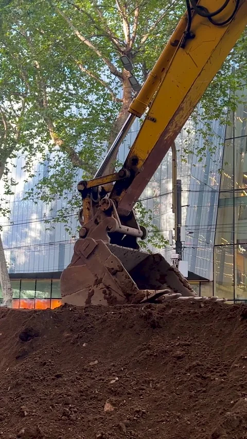 Vertical video close up. Bucket of yellow crawler excavator levels gravel Stock Footage 341274939
