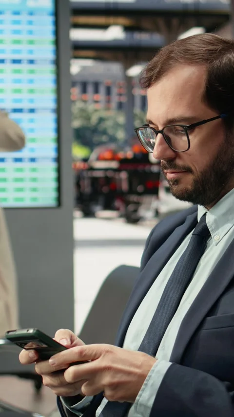 Vertical video Close up of businessman using mobile phone in bus station Stock Footage 341976595