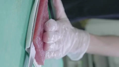 Vertical video Close up of chef hand cutting tuna with knife in kitchen Stock Footage 278930864