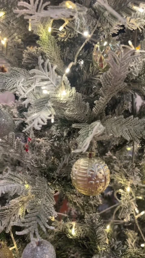Vertical video of close Christmas tree view with frosted branches lights Stock Footage 322967408